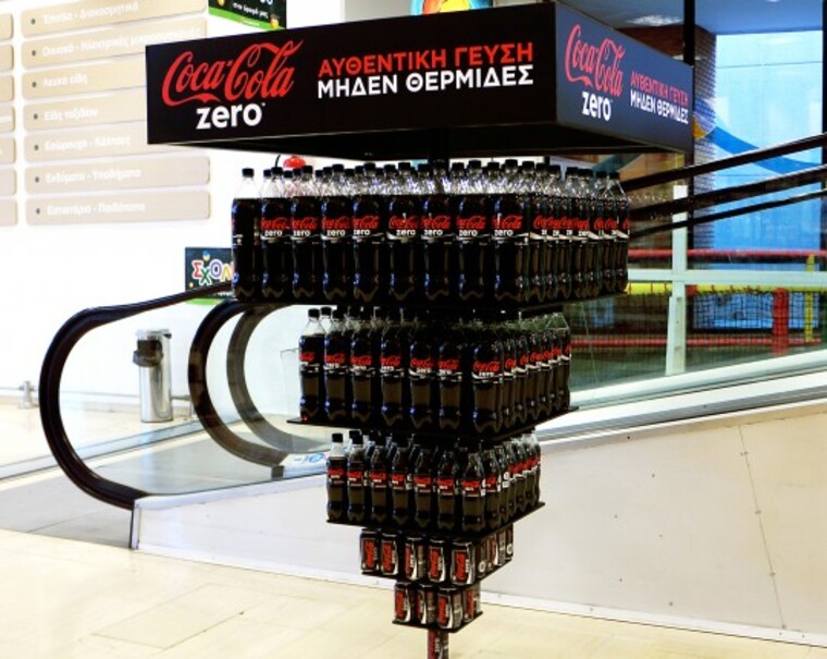 Foto de pirâmide invertida de embalagens de Coca-Cola em campanha realizada em supermercados das Filipinas. 