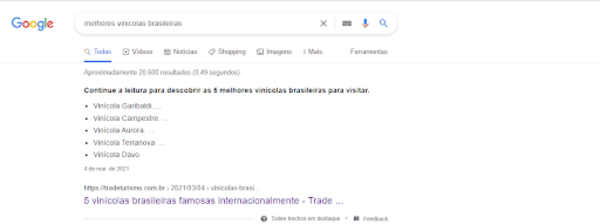 Captura de tela de uma pesquisa no Google por “melhores vinícolas brasileiras”. O snippet é um texto da Trade Turismo em  formato de lista. 